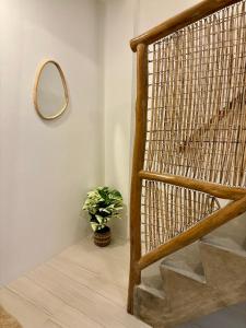 Una escalera con un espejo y una planta en maceta. en Hiraya Apartments, en San Vicente