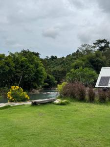 a view of a river with a house and a field at กางเขา แคมป์ปิ้ง in Ban Bung Mai +16 photos