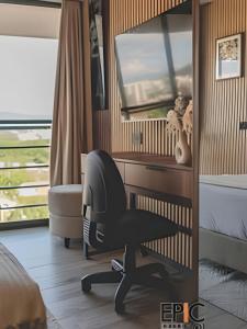 a bedroom with a chair and a desk and a bed at Epic Suite 501 Deluxe Aeropuerto in Cuba