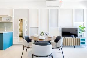 a dining room with a table and chairs at 22 Macalisterz George Town in George Town +94 photos