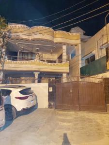 a white car parked in front of a house at Entire Ground Floor Elegance 3BR Gulistan e Joher Blk 14 Near Darul Sehat Hospital in Karachi