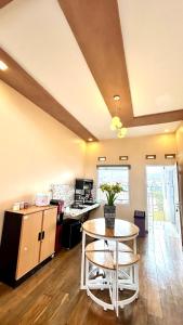 a kitchen with a table and chairs in a room at Sun kissed Dieng Villa in Dieng +4 photos