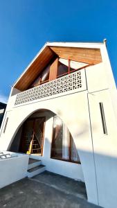 a house with an archway on the side of it at Sun kissed Dieng Villa in Dieng