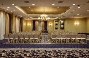 a row of chairs in a room with a chandelier at Limneon Resort & Spa in Kastoria +21 photos