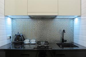 a kitchen with a sink and a counter top at Luxury apartment in Old Town in Klaipėda