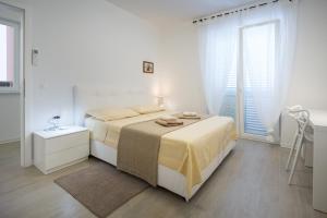 Postel nebo postele na pokoji v ubytování Apartments Tamburini