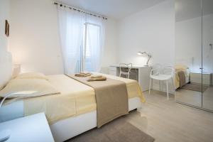 Postel nebo postele na pokoji v ubytování Apartments Tamburini