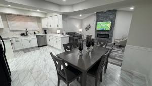a kitchen and dining room with a table and chairs at Modern Family Home -3BR -High Speed Wi-Fi Comfort in Sterling Heights