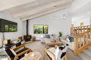 a living room with a couch and a table at Sullivans Retreat - Paihia Holiday Home in Paihia