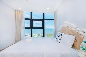 a bedroom with a large bed with a large window at Aria Vũng Tàu Resort - Căn hộ & Villa in Vung Tau +53 photos