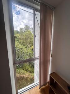 a room with a large window with a view at Modern 3 bedroom apartment Monserrate 360 Santa Rosa in Estación El Salto