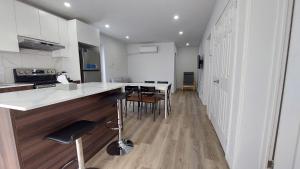 a kitchen with a counter and chairs in a room at River & Mountain View 2BR Apartment Private Parking in McMasterville