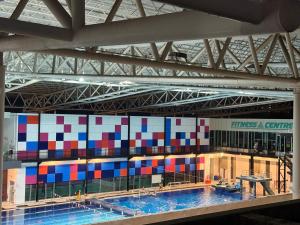 a swimming pool with colorful squares on the wall at SPICE Skyview Luxe Tunas 4B3B in Bayan Lepas