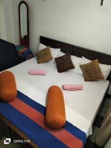 a bed with some pillows on top of it at Beni Beach Resort Batticaloa, Sri Lanka in Kallady