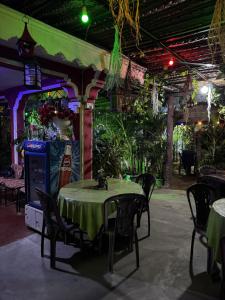 a table and chairs in a restaurant with a green table cloth at Beni Beach Resort Batticaloa, Sri Lanka in Kallady +49 photos