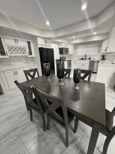 a kitchen with a table with two wine glasses on it at Modern Family Home -3BR -High Speed Wi-Fi Comfort in Sterling Heights +8 photos