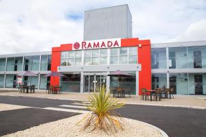 a large building with a sign in front of it at Ramada Milton Keynes in Milton Keynes