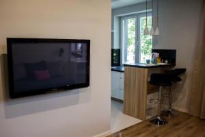 a living room with a flat screen tv on a wall at A3XD Apartament in Częstochowa