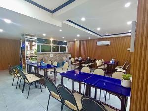 a dining room with blue tables and chairs at Memory Hotel Vientiane in Vientiane