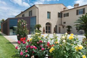 a house with flowers in front of it at Pistoia Nursery Campus - agriturismo in citt&agrave; in Pistoia