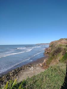 a view of the beach from a bluff at Departamento en la Playa Pura Vida MDQ in Mar del Plata