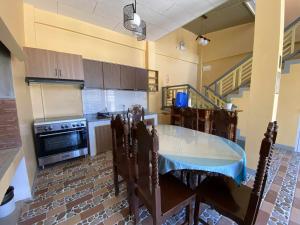 a kitchen with a table in the middle of it at Jean Apartelle in Loon +8 photos