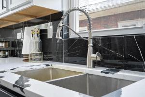 a kitchen counter with a sink in a kitchen at North Chi retreatNavySaunaTiki BarGames in North Chicago