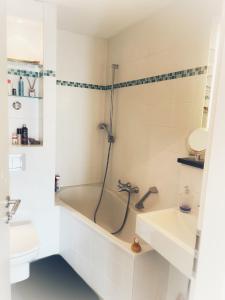 a bathroom with a bath tub and a sink at Octoberfest room in Unterschleißheim
