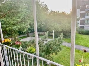 a view of a garden from a balcony at Octoberfest room in Unterschleißheim