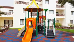 a playground in front of a building at Vitalclass Lanzarote Resort in Costa Teguise