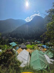 a view of a village with mountains in the background at Jalpa Camp Kasol in Kulu