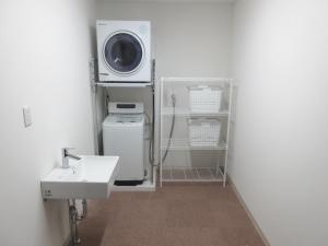 a bathroom with a sink and a washing machine at 森口屋アートスクエア in Shodoshima +38 photos