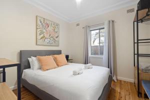 a bedroom with a bed with a teddy bear on it at Nordic House in Forster