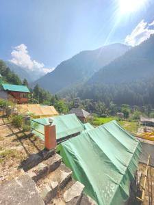 a view of a mountain with a green roof at Jalpa Camp Kasol in Kulu