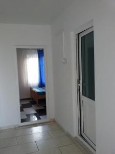 a hallway with a door to a room with a window at Vila Happy -only adults in Costinesti