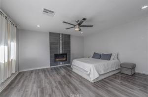 a white bedroom with a bed and a fireplace at 近ONT机场 Chaffey Claremont学院 Ontario Outlets 3Br2BA in Rancho Cucamonga