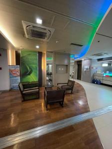 a lobby with two chairs and a large screen at Antel Spa Residences 10EE in Manila