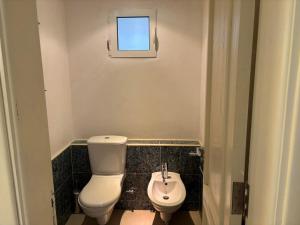 a small bathroom with a toilet and a sink at Domina Coral Bay Resort Elisir in Sharm El Sheikh