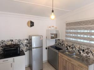 a kitchen with a refrigerator and a sink at Long on Hill in Johannesburg