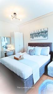 a bedroom with a large white bed with at The Lumiére Stays Sophisticated Escape Mallside Charm in Trece Martires +18 photos