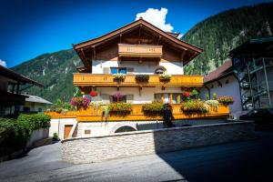 a building with flower boxes on the side of it at Moroder Haus in Mayrhofen