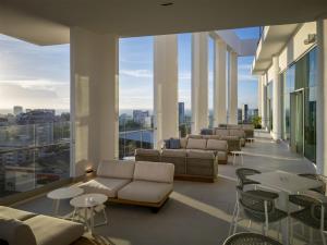 a large room with couches and tables and windows at Hyatt Centric Santo Domingo in Santo Domingo