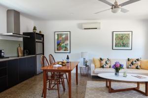 a kitchen and a living room with a table at Goldfield Holiday Units in Bright