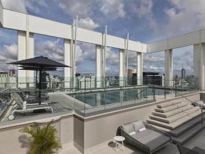 a balcony with a swimming pool on a building at Hyatt Centric Santo Domingo in Santo Domingo