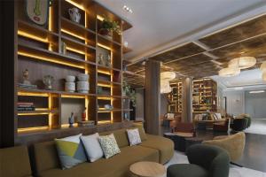 a lobby with a couch and chairs and shelves at Hyatt Centric Santo Domingo in Santo Domingo