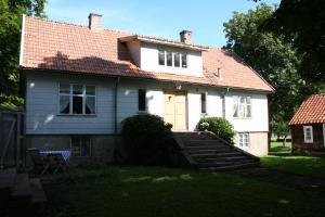 a white house with a red roof and stairs at Greby Bed & Breakfast in Räpplinge