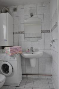 a white bathroom with a sink and a mirror at Miód Malina in Nałęczów