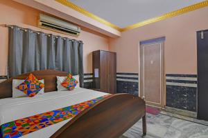 a bedroom with a large bed in a room at FabHotel Relyef Inn in kolkata