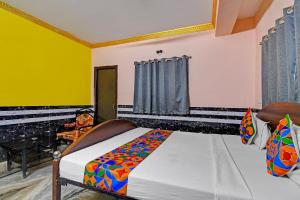 a bedroom with a bed in a room at FabHotel Relyef Inn in kolkata