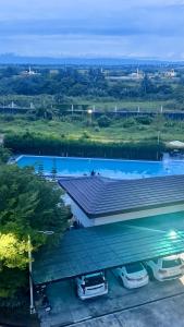 a large building with cars parked in a parking lot at CoZerenity Stays - Premium two-bedroom Condo in Concepcion